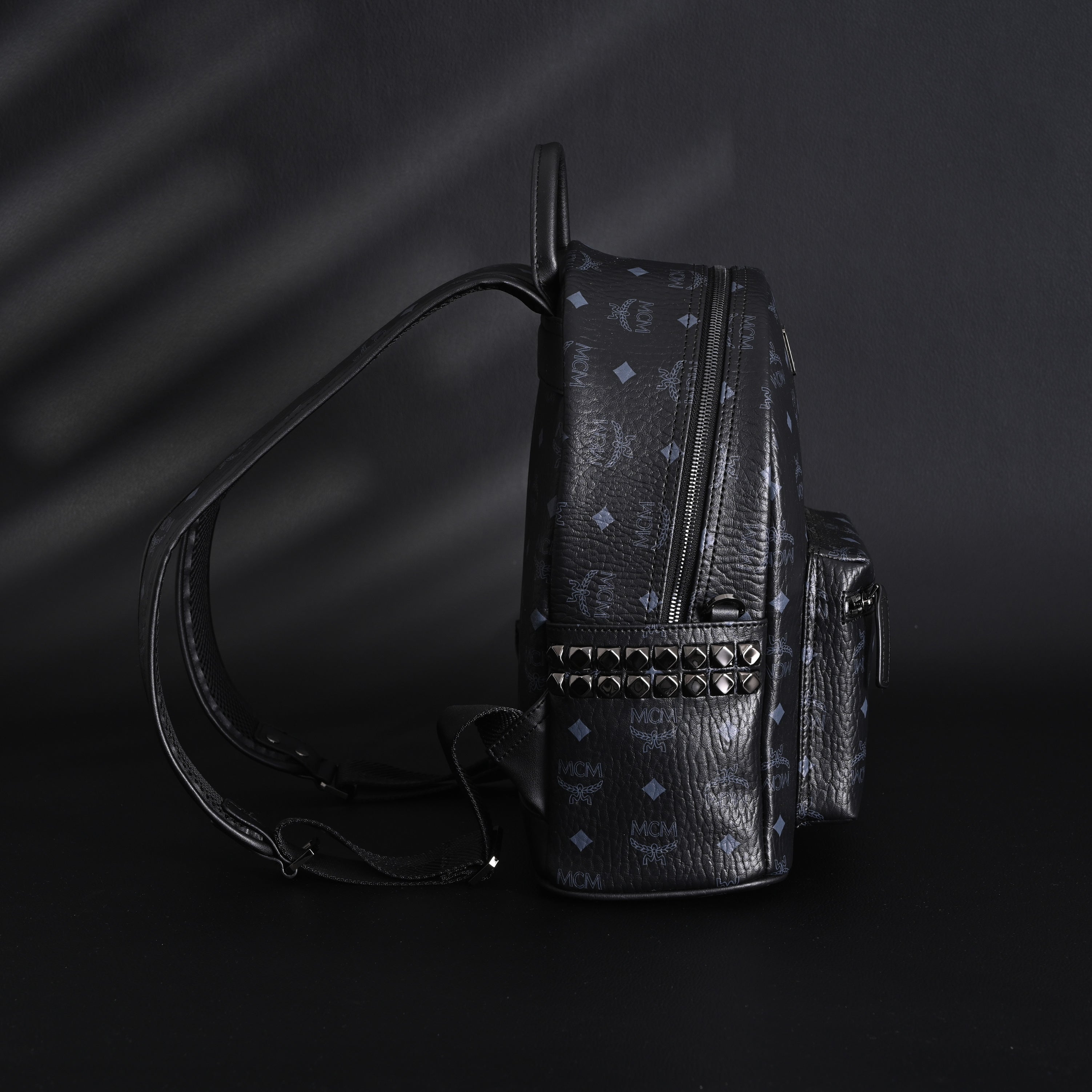 MCM Stark Visetos Medium Backpack – Black Monogram with Studded Detailing
